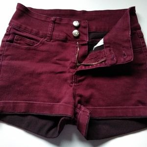 Dark red, high waisted shorts.